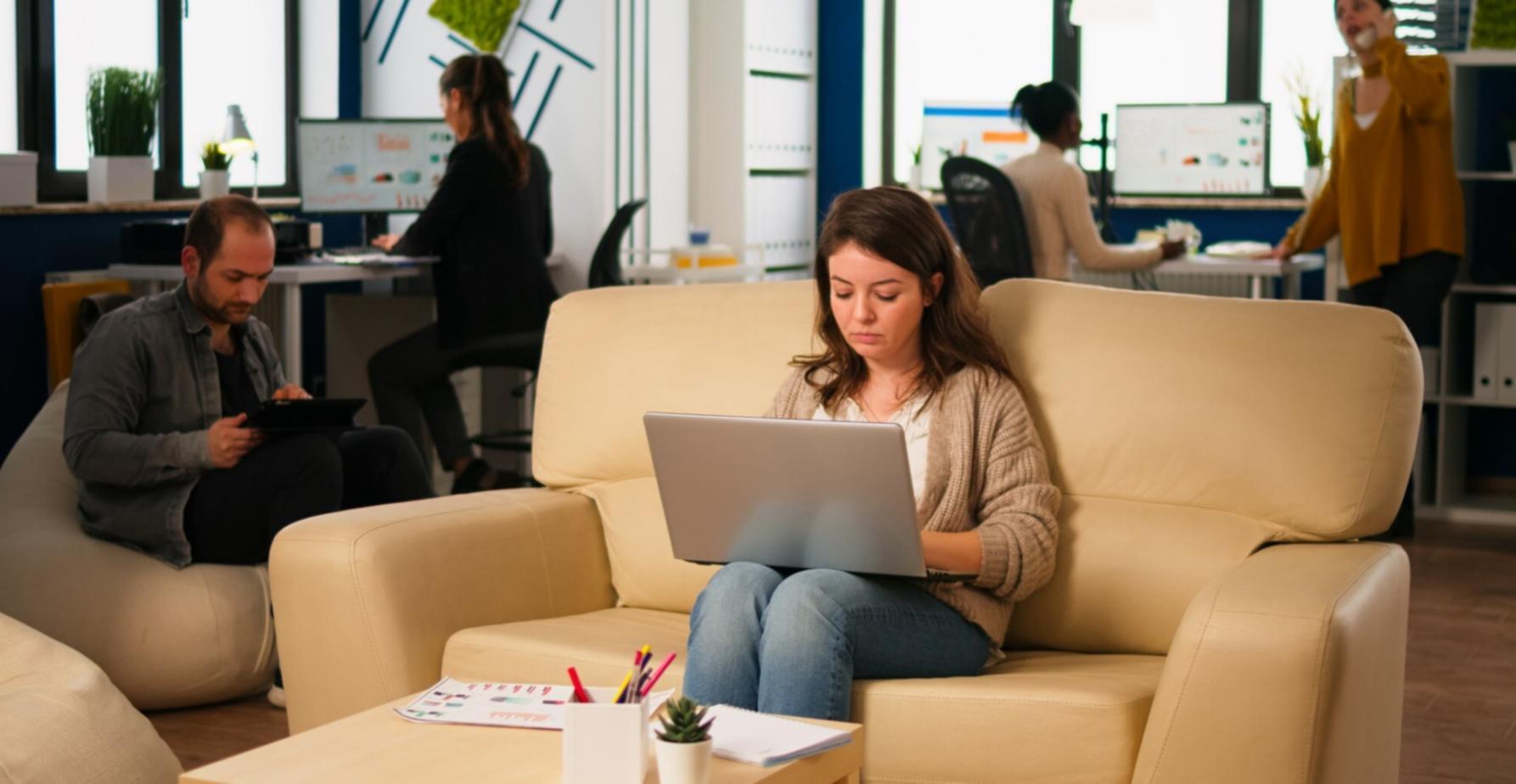 Student reviewing financial analysis materials on laptop with notebook